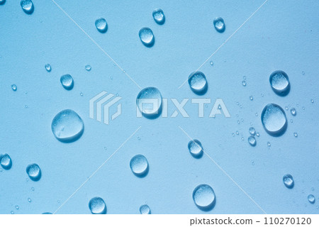 Transparent round drops of clear liquid, hyaluronic acid. Abstract blue cosmetic backdrop with splash, water spray 110270120