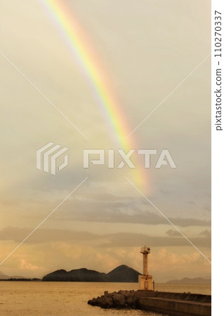 Rainbow over the sea at dusk in autumn 110270337