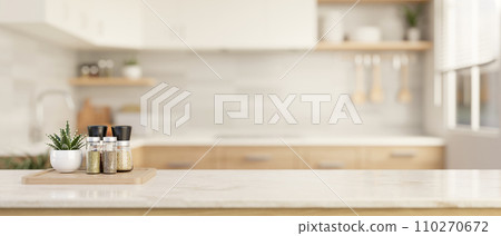 Spice bottles and copy space on a luxury white marble tabletop in a modern bright and clean kitchen. 110270672