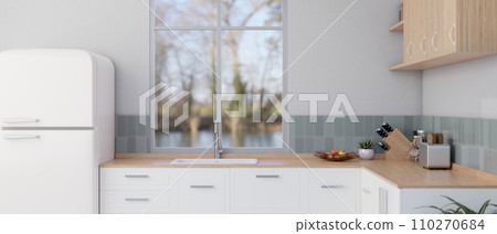 A modern and clean kitchen with minimalist kitchen counter, a fridge, a sink, and kitchen appliances 110270684