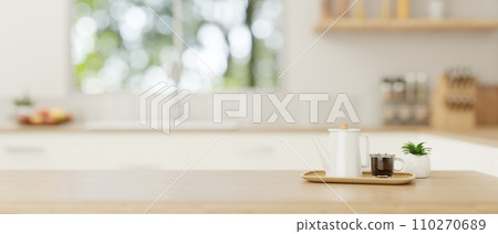 A copy space on a wooden tabletop with a coffee pot and a coffee cup in a minimal bright kitchen. 110270689