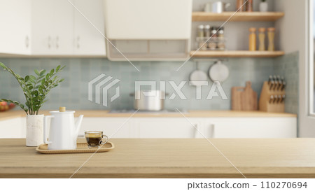 A wooden tabletop with a coffee pot, a coffee cup, and a copy space in a modern kitchen. A wooden tabletop with a coffee pot, a coffee cup, and a copy space in a modern kitchen. 110270694