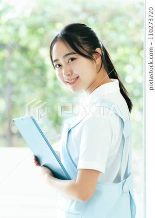 站在窗邊的年輕女性護理人員 110273720