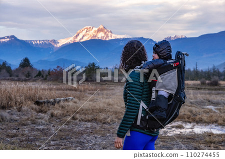 Mother with Baby in Carrier Hiking in Canadian Nature. Mother with Baby in Carrier Hiking in Canadian Nature. 110274455