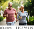 Energetic senior couple with vibrant smiles and athletic poise jogging through a lush park, a tribute to enduring vitality and the beautiful dynamic of couple's goals in the golden years 110276419