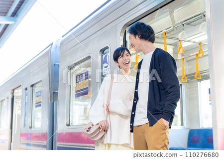 A young couple going on a train trip. Photography provided by Keio Electric Railway Co., Ltd. 110276680