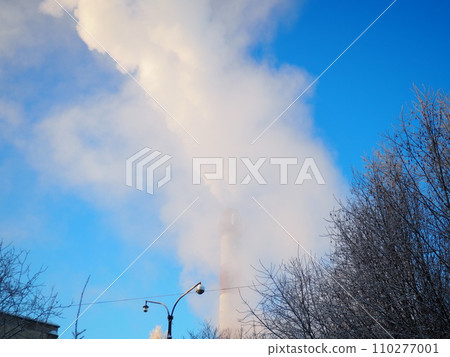 Smoke from a factory chimney. Ecological pollution. Air emissions polluting forest. Industrial waste. Industry metallurgical plant emissions. Smog and bad ecology. Central heating of CHP in winter. 110277001