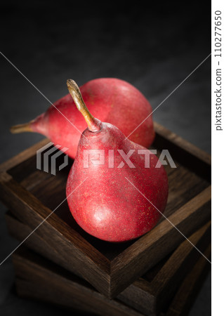 Red pear on wooden background 110277650