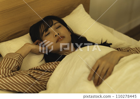 Woman sleeping deeply in bed 110278445