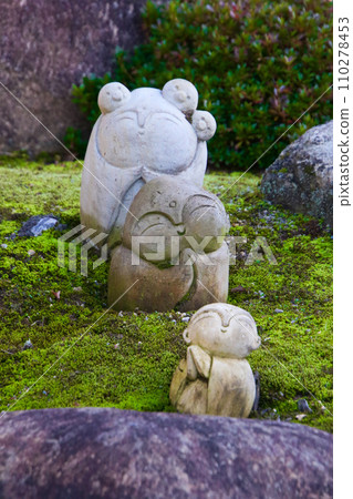 Jizo placed in a garden with moss 110278453