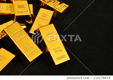 Close up photo a gold bar on black background 110278619