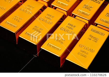 Close up photo a gold bar on black background 110278626