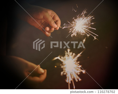 Holding a sparkler for special day . BLUR BACKGROUND 110278702
