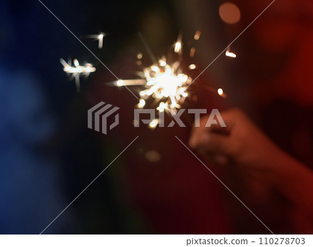 Holding a sparkler for special day . BLUR BACKGROUND 110278703
