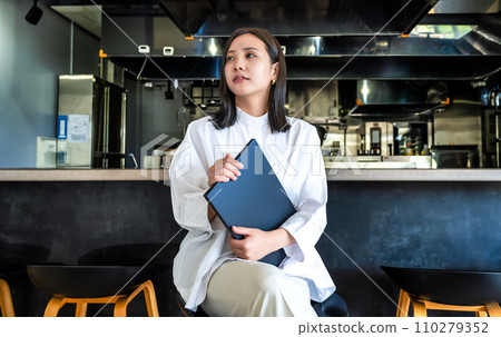 Restaurant owner, young woman with a laptop 110279352