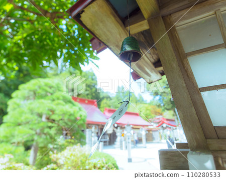 Wind chimes sway in the breeze 110280533