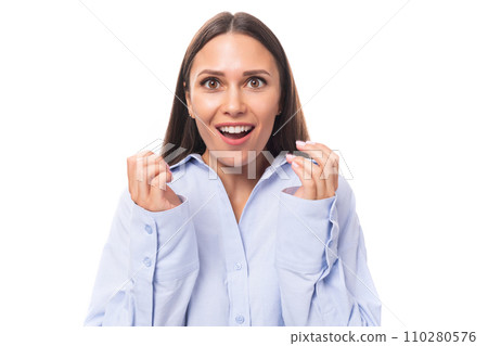 portrait of a surprised well-groomed young brunette caucasian woman with straight hair dressed in a portrait of a surprised well-groomed young brunette caucasian woman with straight hair dressed in a 110280576