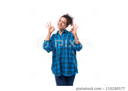 young smiling energetic curly european woman dressed casually in a blue plaid shirt on a white young smiling energetic curly european woman dressed casually in a blue plaid shirt on a white 110280577