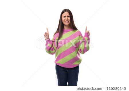 stylish cheerful young brunette woman in a striped pink blouse points fingers at the space for stylish cheerful young brunette woman in a striped pink blouse points fingers at the space for 110280840
