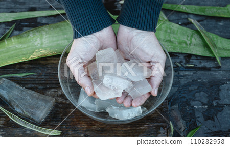 man puts some pieces of aloe vera gel in a bowl 110282958