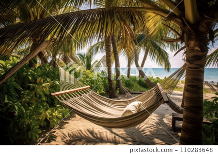 Relax in a beachfront hammock under swaying palms. 110283648