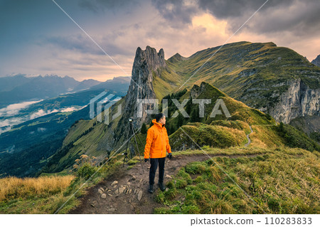 Landscape of rocky mountains of Saxer Lucke with male traveler hiking on Swiss Alps in autumn at Switzerland Landscape of rocky mountains of Saxer Lucke with male traveler hiking on Swiss Alps in autumn at Switzerland 110283833