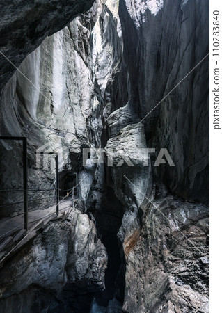 Natural limestone cave in the canyon and pathway in Rosenlaui glacier gorge at Switzerland Natural limestone cave in the canyon and pathway in Rosenlaui glacier gorge at Switzerland 110283840