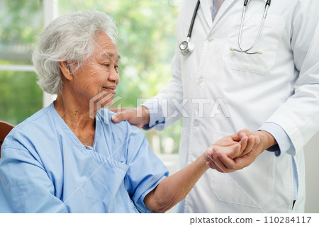 Doctor holding hands Asian elderly woman patient, help and care in hospital. Doctor holding hands Asian elderly woman patient, help and care in hospital. 110284117