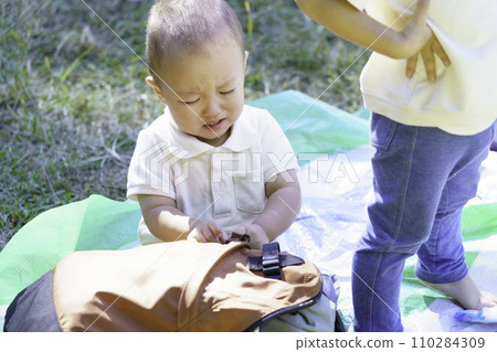 boy sitting and crying in the park 110284309