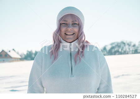 Young Caucasian Beautiful pink hair woman smile at camera taking selfie photo or video call in winter snow forest  110284527