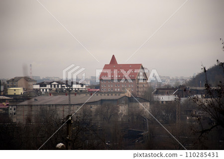From below of entrance of office building next to contemporary high rise structures with glass mirrored walls and illuminated lights in calgary city against cloudless From below of entrance of office building next to contemporary high rise structures with glass mirrored walls and illuminated lights in calgary city against cloudless 110285431