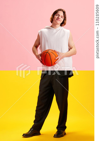 Sport and professional lifestyle. Collage made of halves of images. Young man in sportswear with basketball ball and in formal pants. Sport and professional lifestyle. Collage made of halves of images. Young man in sportswear with basketball ball and in formal pants. 110285609