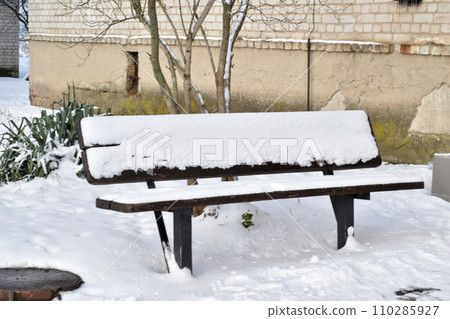 Winter. The bench is covered with snow. Winter. The bench is covered with snow. 110285927
