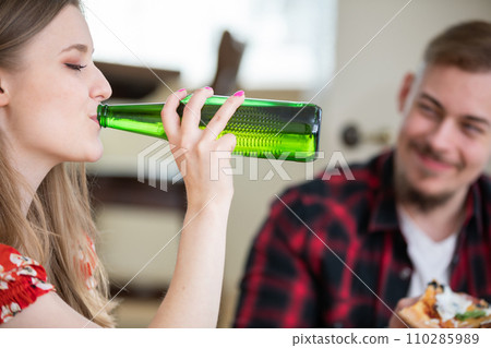 Close-up of a blonde woman drinking from a bottle Close-up of a blonde woman drinking from a bottle 110285989