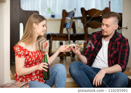 Weekend party for friends over beer and pizza 110285991