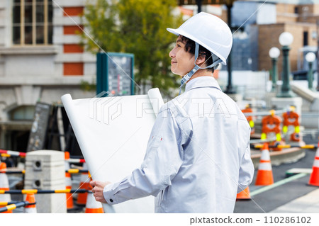 Site supervisor checking drawings at the construction site 110286102