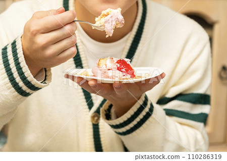 A man eating a piece of cake A man eating a piece of cake 110286319