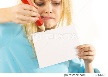 Woman with big pencil writing on paper Woman with big pencil writing on paper 110286668