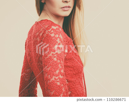 Elegant young woman wearing red top 110286671