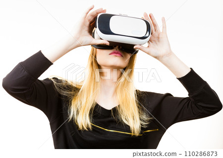 Woman wearing VR goggles Woman wearing VR goggles 110286873