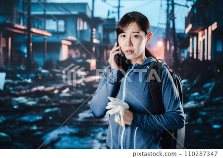 A woman who is having trouble connecting by phone after a disaster occurs A woman who is having trouble connecting by phone after a disaster occurs 110287347
