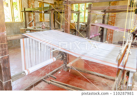 Cotton weaving on a traditional wooden handloom Cotton weaving on a traditional wooden handloom 110287981