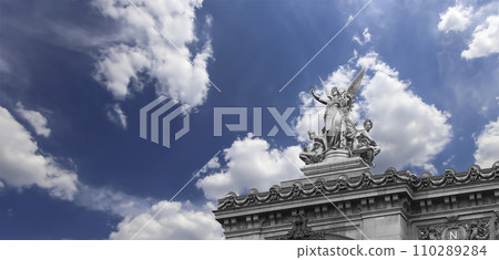 Golden statue of Liberty on the roof of the Opera Garnier (Garnier Palace)  against the sky with clouds. Sculpted by Charles Gumery in 1869. Paris, France. UNESCO World Heritage Site 110289284