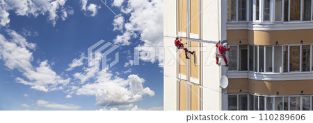 Repair work at height (sealing seams in a panel house), against the sky with clouds. Worker insulates the seams of the facade of an old residential building. Maintenance of residential buildings Repair work at height (sealing seams in a panel house), against the sky with clouds. Worker insulates the seams of the facade of an old residential building. Maintenance of residential buildings 110289606