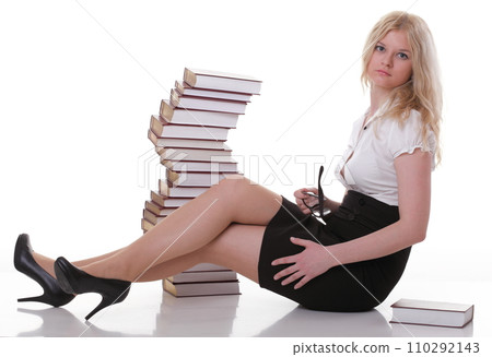 Beautiful young woman with books white background 110292143