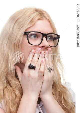 pretty woman with hands over mouth pretty woman with hands over mouth 110292283
