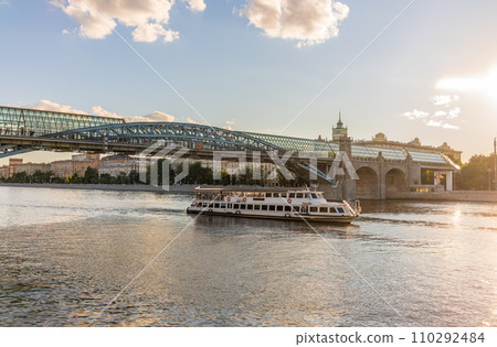 View of the Moscow river embakment, Pushkinsky bridge and cruise ships at sunset. View of the Moscow river embakment, Pushkinsky bridge and cruise ships at sunset. 110292484