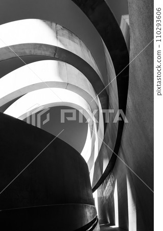 Striking monochrome architectural feature with sweeping curves and a dynamic interplay of light and shadow 110293606