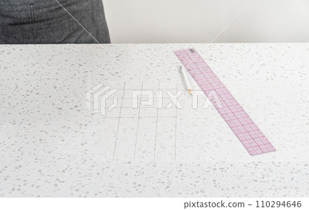 Preparing cutting template from parchment paper to cut homemade fudge. 110294646