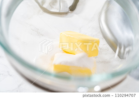 Mixing ingredients in kitchen electric mixer to bake panda-shaped shortbread cookies with chocolate icing. 110294707